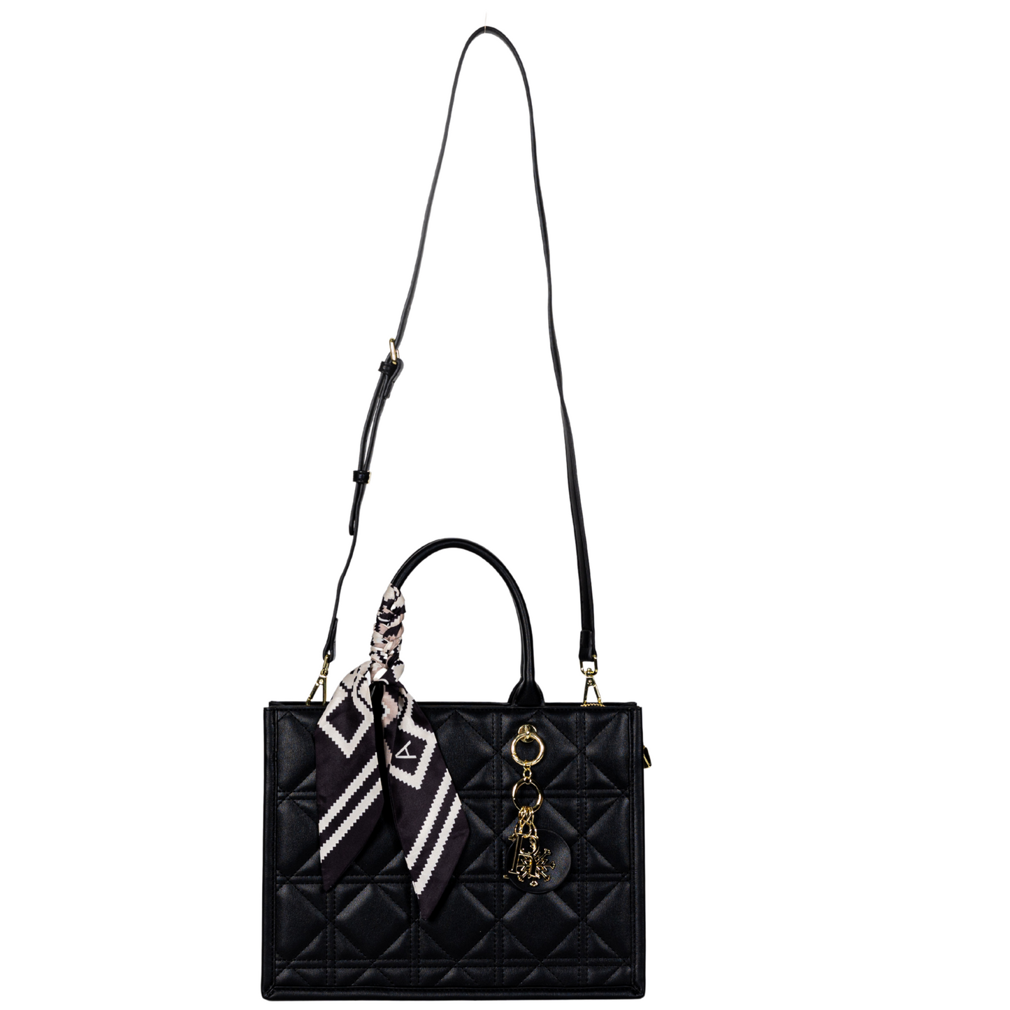 Sayan black quilted tote with gold charms, adjustable strap, and patterned scarf.