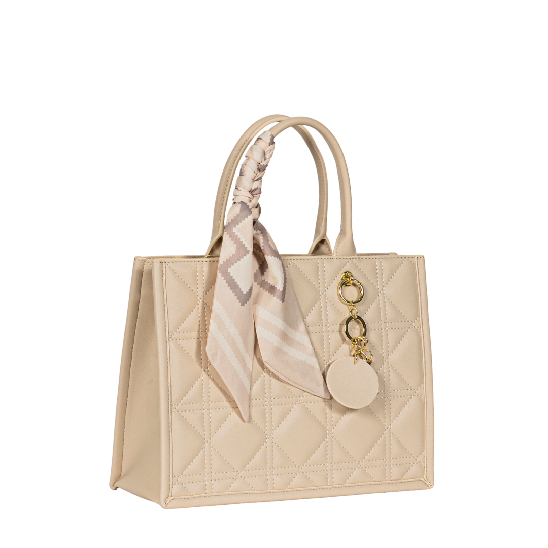 Sayan's Top Zip Handbag Tote is a beige quilted bag with scarf, keychain, top handles, and structured design.