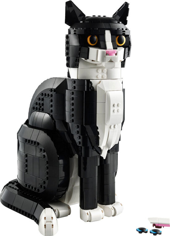 A LEGO® Tuxedo Cat - ONLINE ONLY by LEGO sits upright, with extra pieces nearby.