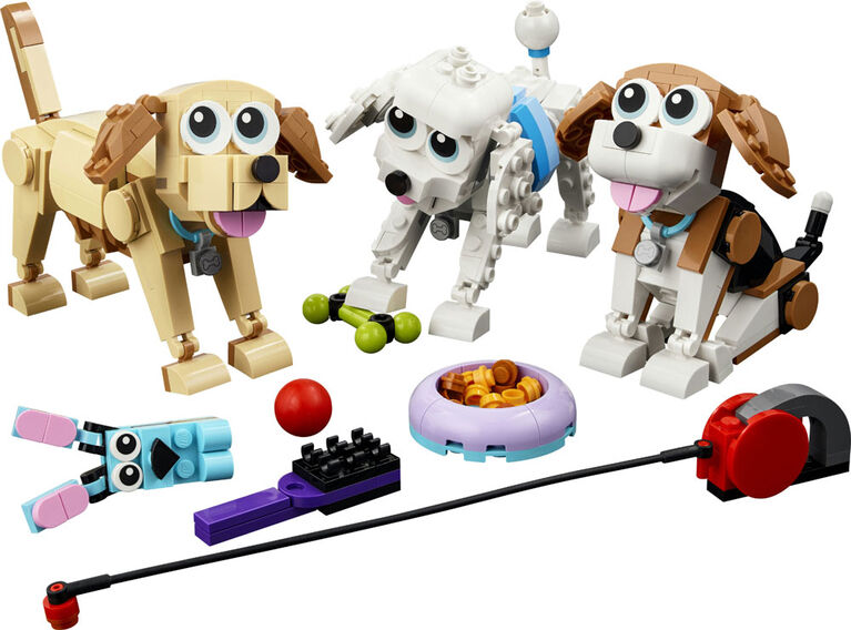 Three LEGO® Adorable Dogs - ONLINE ONLY sets by LEGO with bowl, toys, treats, and red leash on white background.