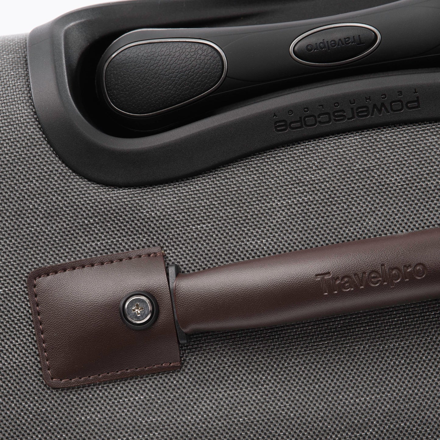 Close up of brown leather grab handle on top of the vintage grey Travelpro® Platinum® Elite 25" Expandable Spinner