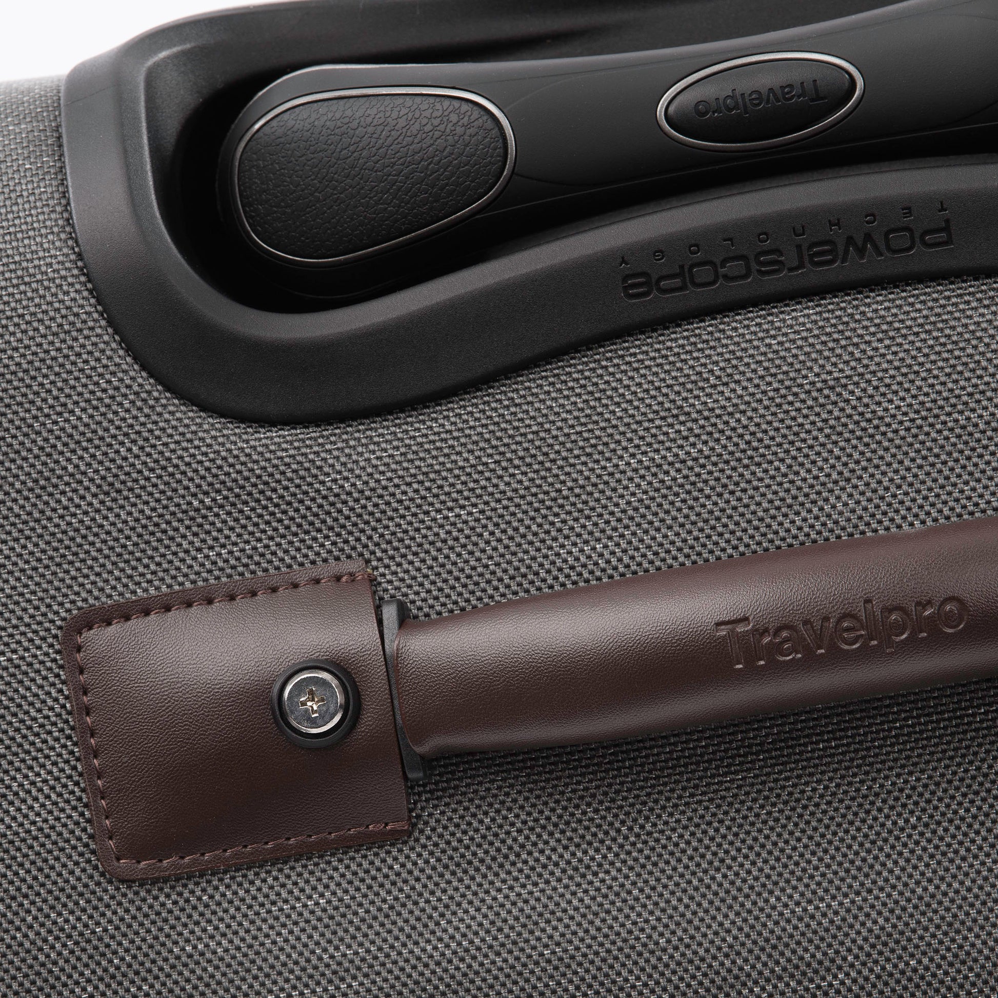 Close up of brown leather grab handle on top of the vintage grey Travelpro® Platinum® Elite 25" Expandable Spinner
