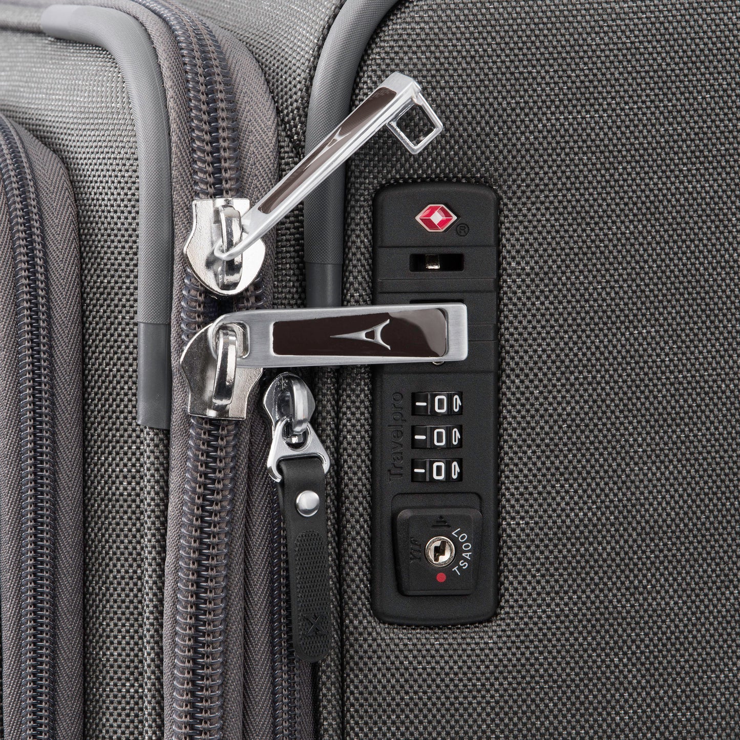 Close up of lockable zipper pulls and TSA lock on side of vintage grey Travelpro® Platinum® Elite 25" Expandable Spinner
