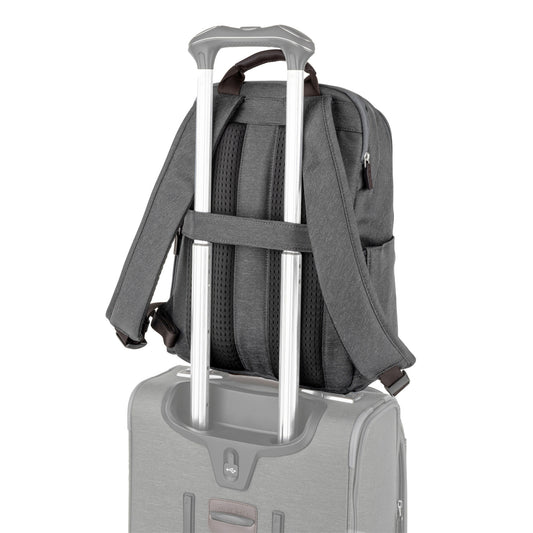 Product Image – Travelpro® Platinum® Elite Slim Backpack, vintage grey with brown leather details, back angled view with luggage strap around extended telescopic handle of a suitcase