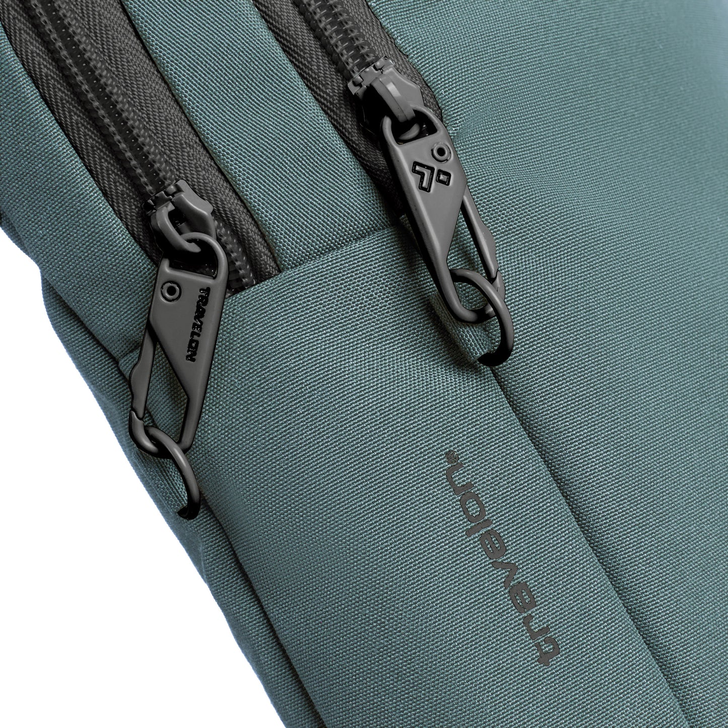 Close-up of the slate blue Travelon Voyages Anti-Theft Slim Bag with locking zipper pulls.