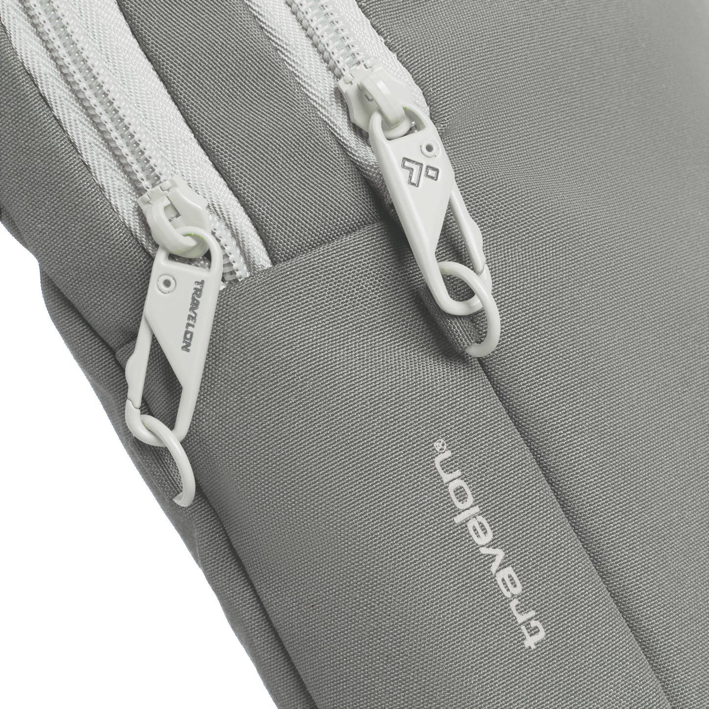 Close up of whtte locking zippers on the granite Travelon Voyages Anti-Theft Slim Bag.