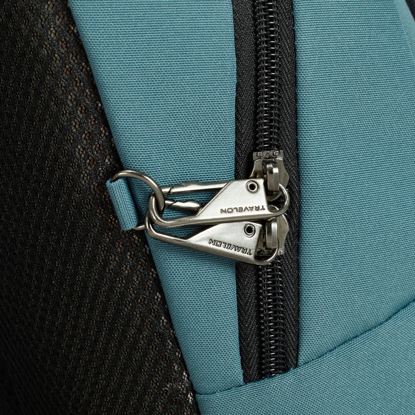 Close-up of the slate blue Travelon Voyages Anti-Theft Backpack zipper with interlocked clips for added security.