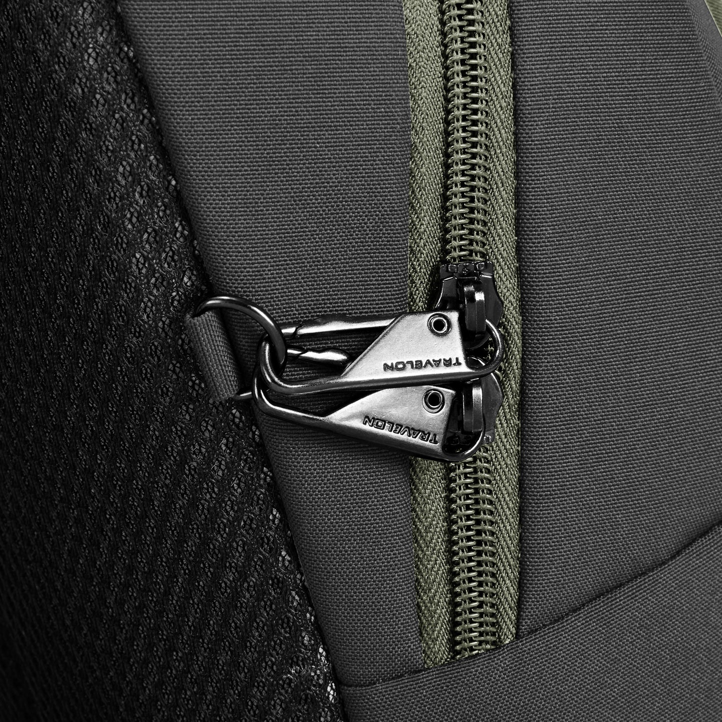 Close-up of lockable zippers on the Travelon Voyages Anti-Theft Small Backpack.