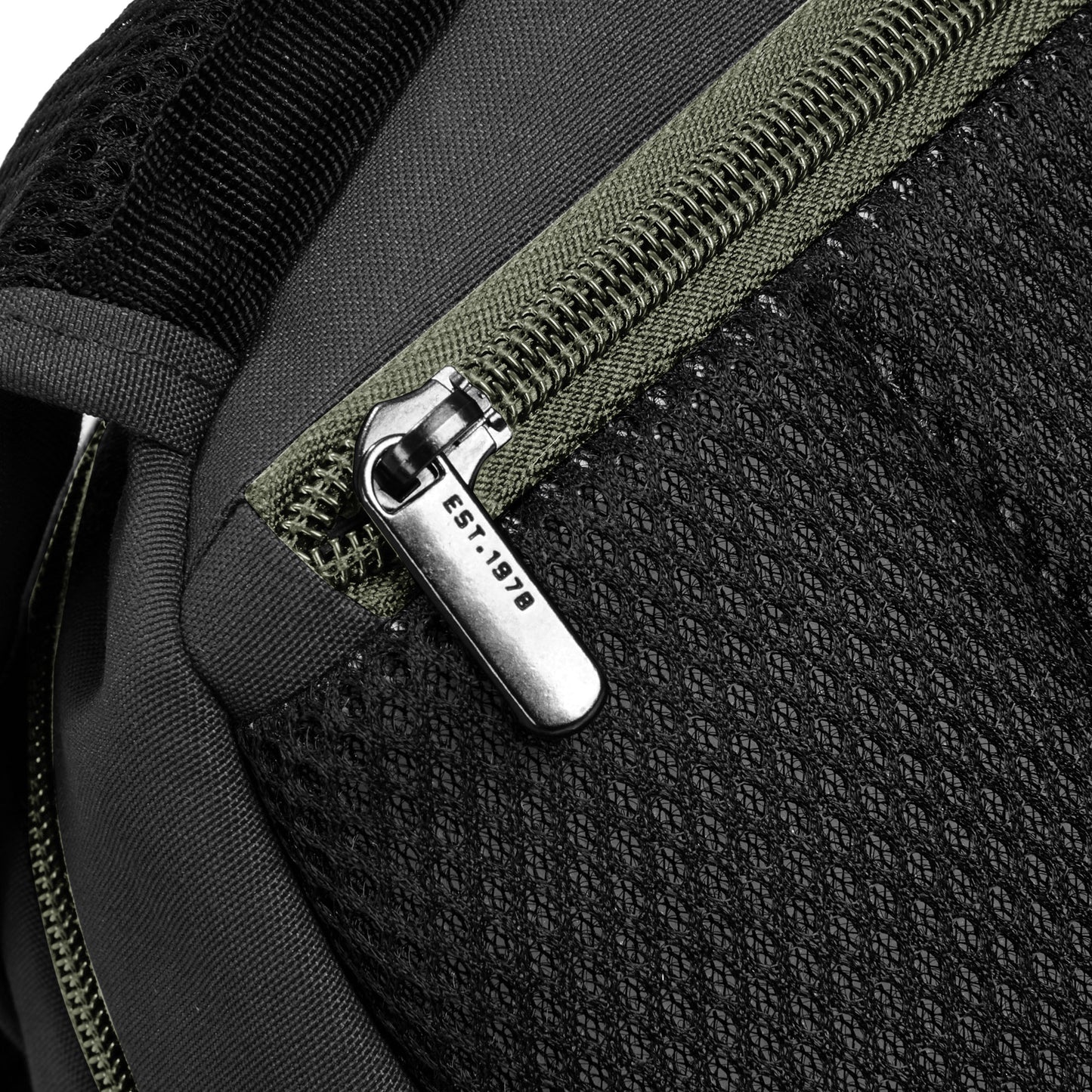 Close-up of the back security zippered pocked on the Travelon Voyages Anti-Theft Backpack in black.