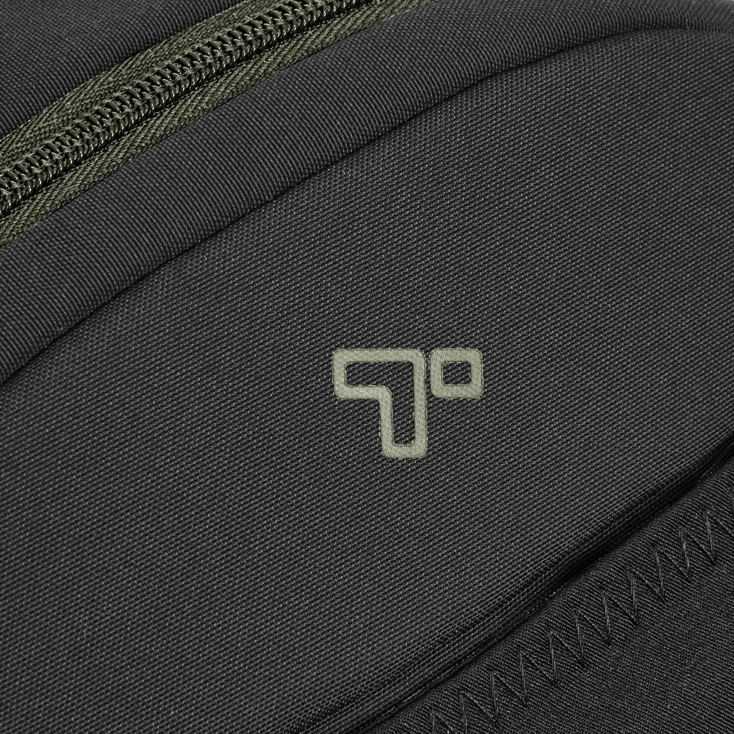 Close-up of a Travelon Voyages anti-theft backpack in black with a green zipper and logo.