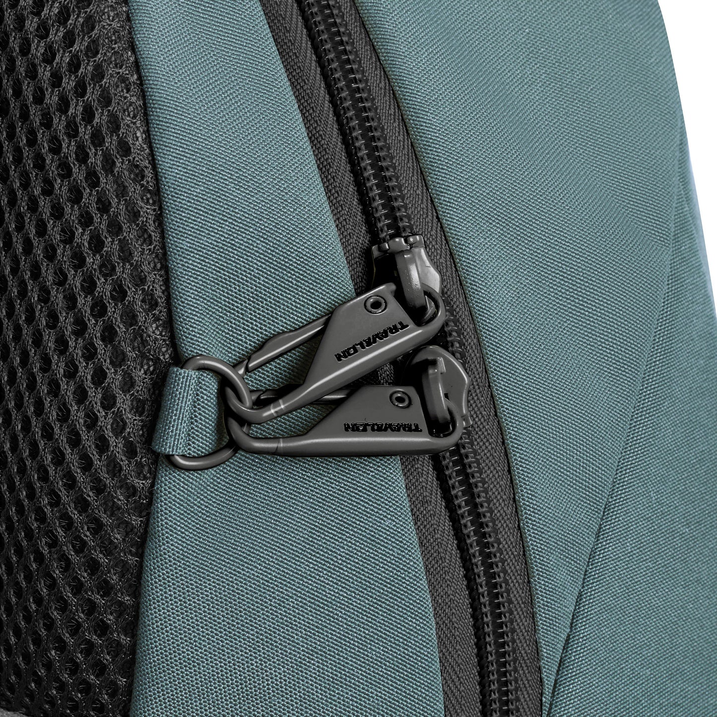 Close-up of Travelon Voyages Anti-Theft Day Pack in slate blue, with slash-resistant design, black mesh, and two lockable zippers.