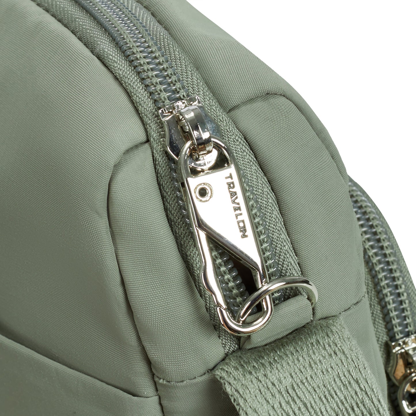 Close up of locking zipper pull on moss Travelon Roam Anti-theft East/West Crossbody.