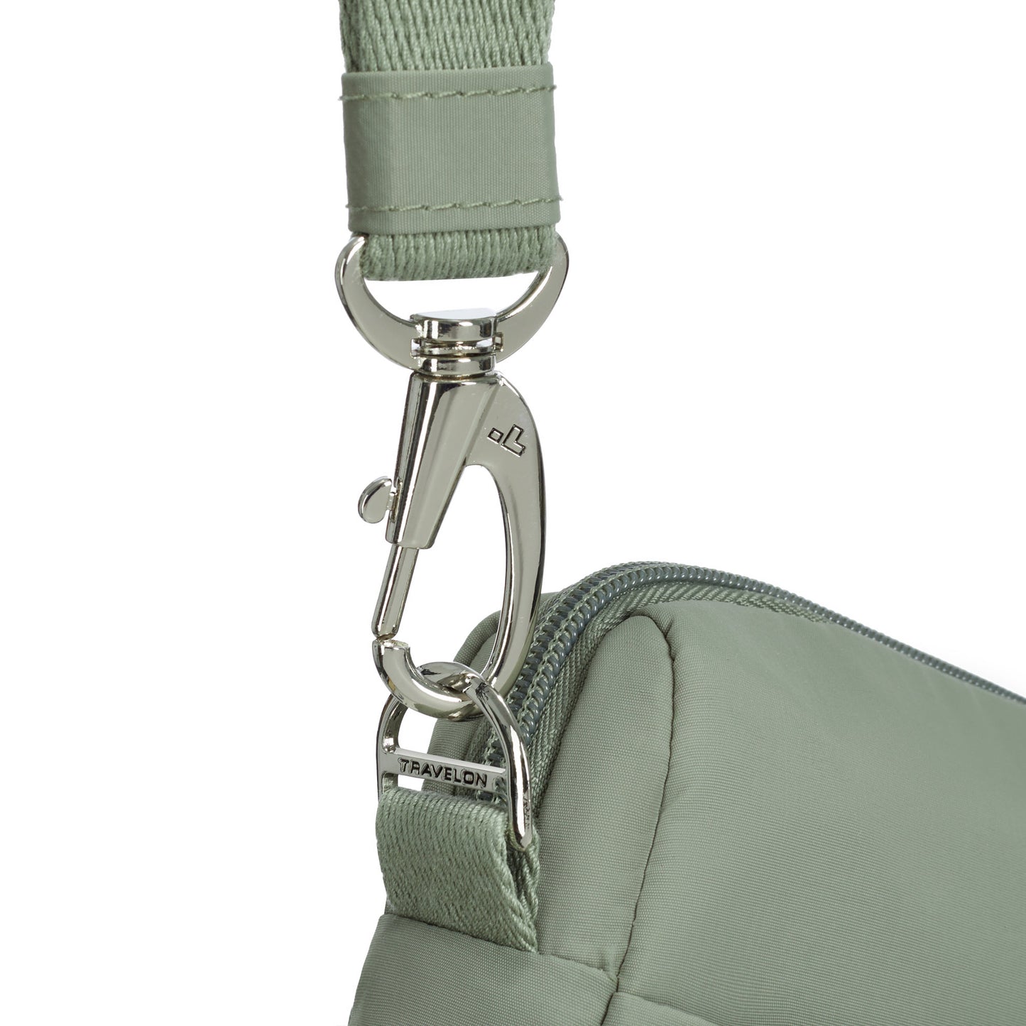 Close up of clip on crossbody strap of moss Travelon Roam Anti-theft East/West Crossbody.