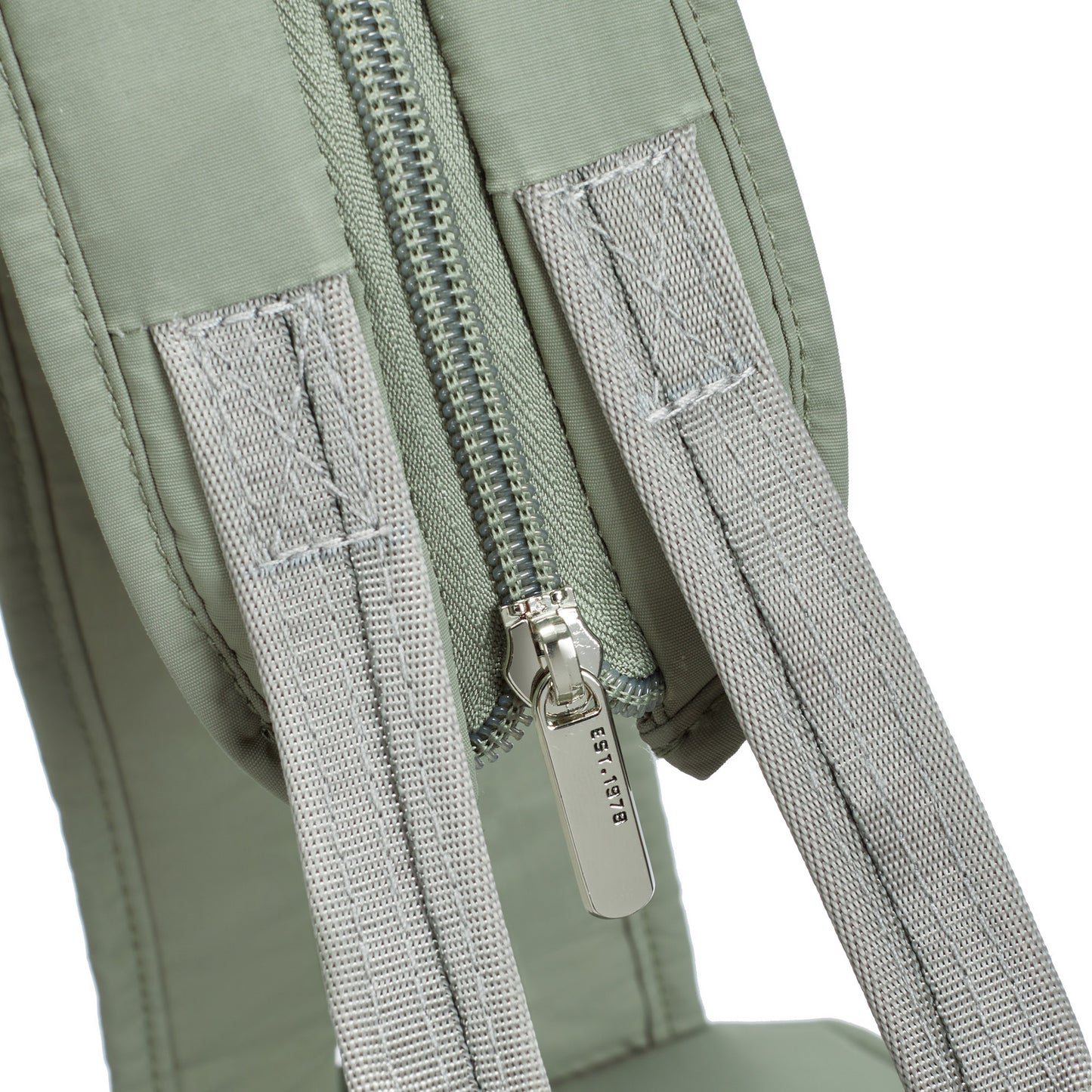 Close-up of the Travelon Roam moss green convertible backpack with grey straps and a secure silver zipper.