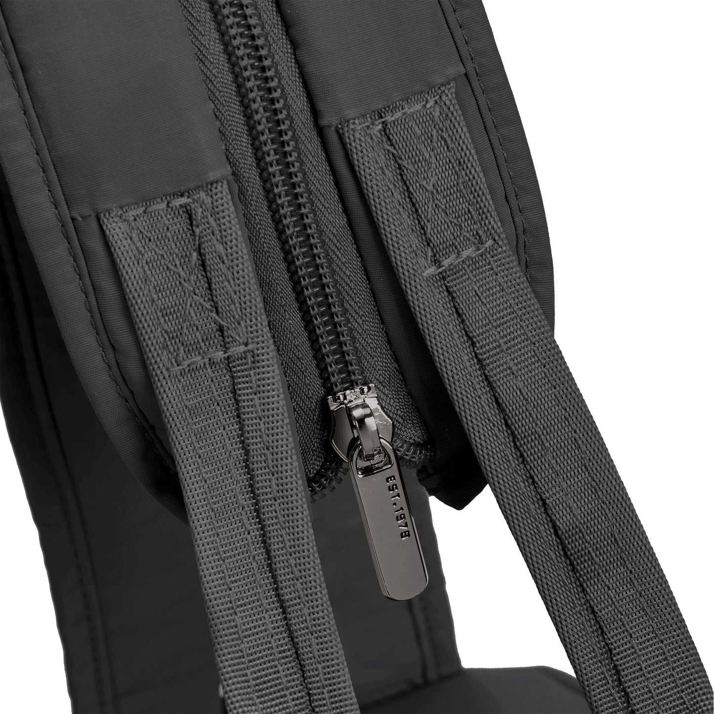 Close-up of a black Travelon Roam backpack with an anti-theft zipper and brand name on the pull.
