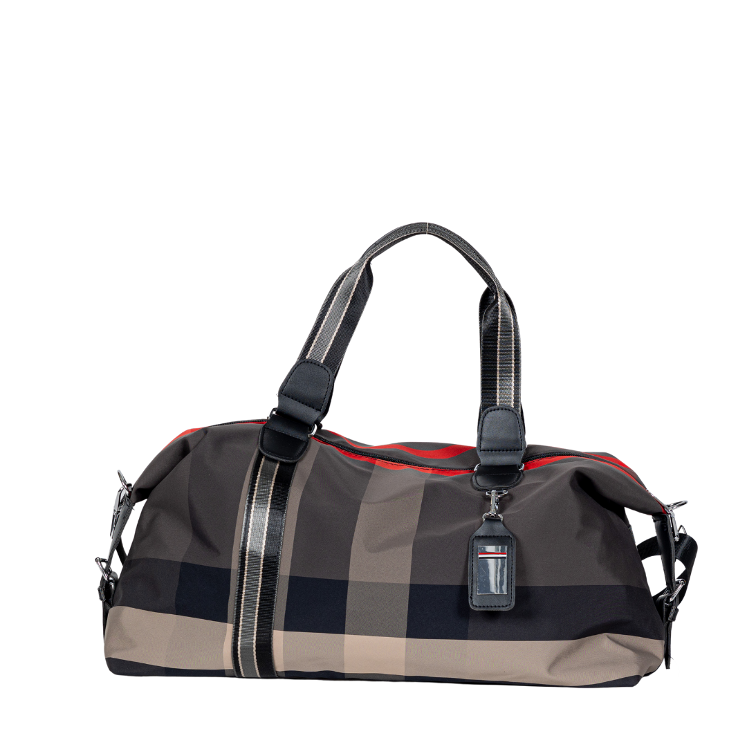 Sayan Duffle Bag features a plaid pattern, black handles, luggage tag, and red accents.