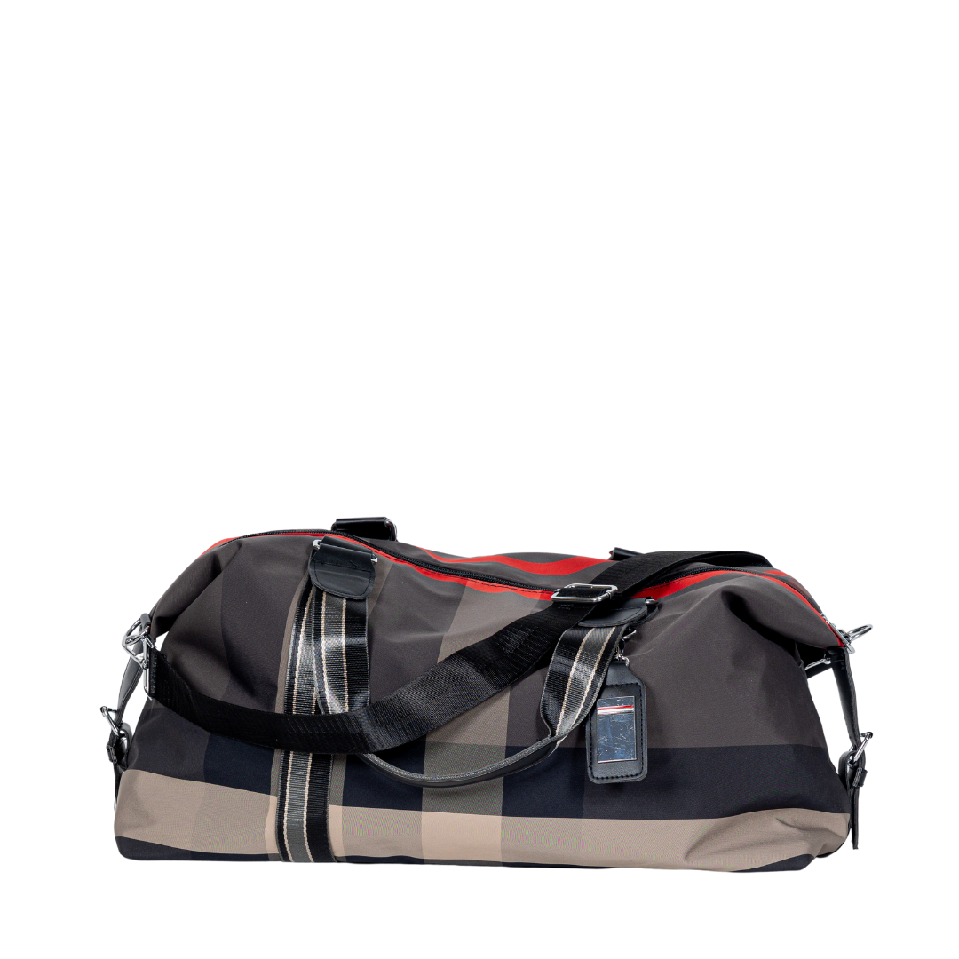 Sayan Duffle Bag, featuring plaid design and black straps, includes a luggage tag.