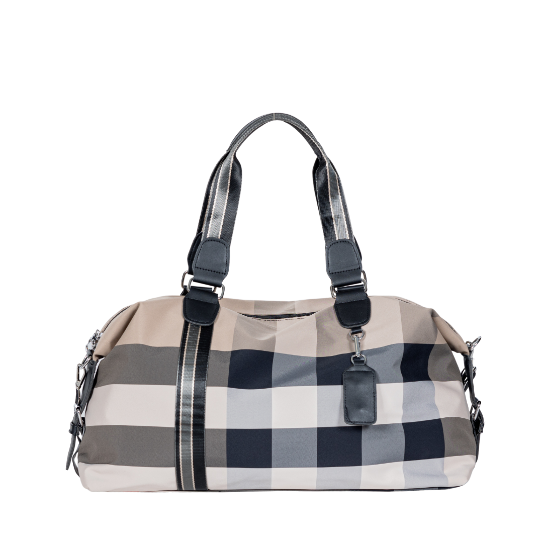 The Sayan Duffle Bag is a checkered carry-on with black handles and a tag, made of quality nylon, on white.
