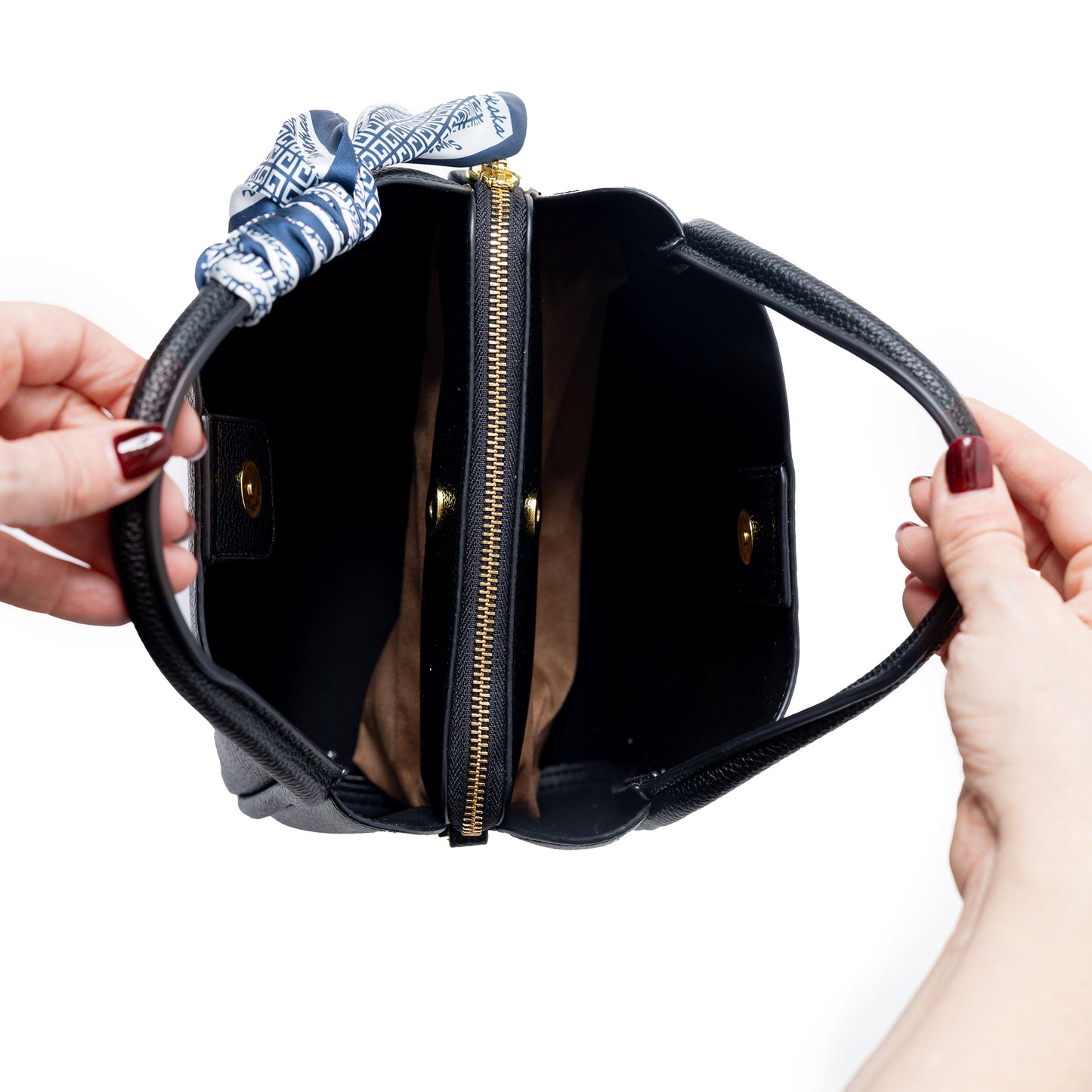 Hands hold a Miss Caprice Abby Triple Compartment Tote with a scarf, adjustable strap, and spacious interior.