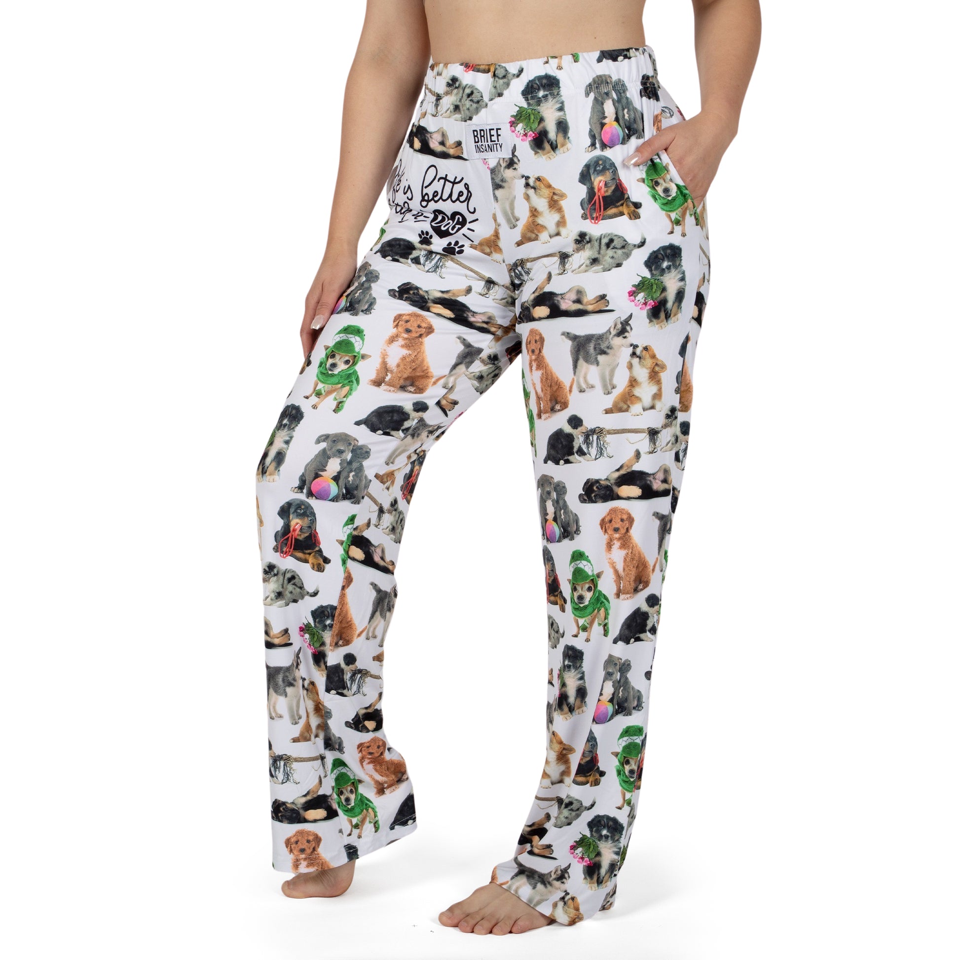 Woman models Brief Insanity Lounge Pants—cute dog print, pockets, barefoot; ideal gift for dog lovers.