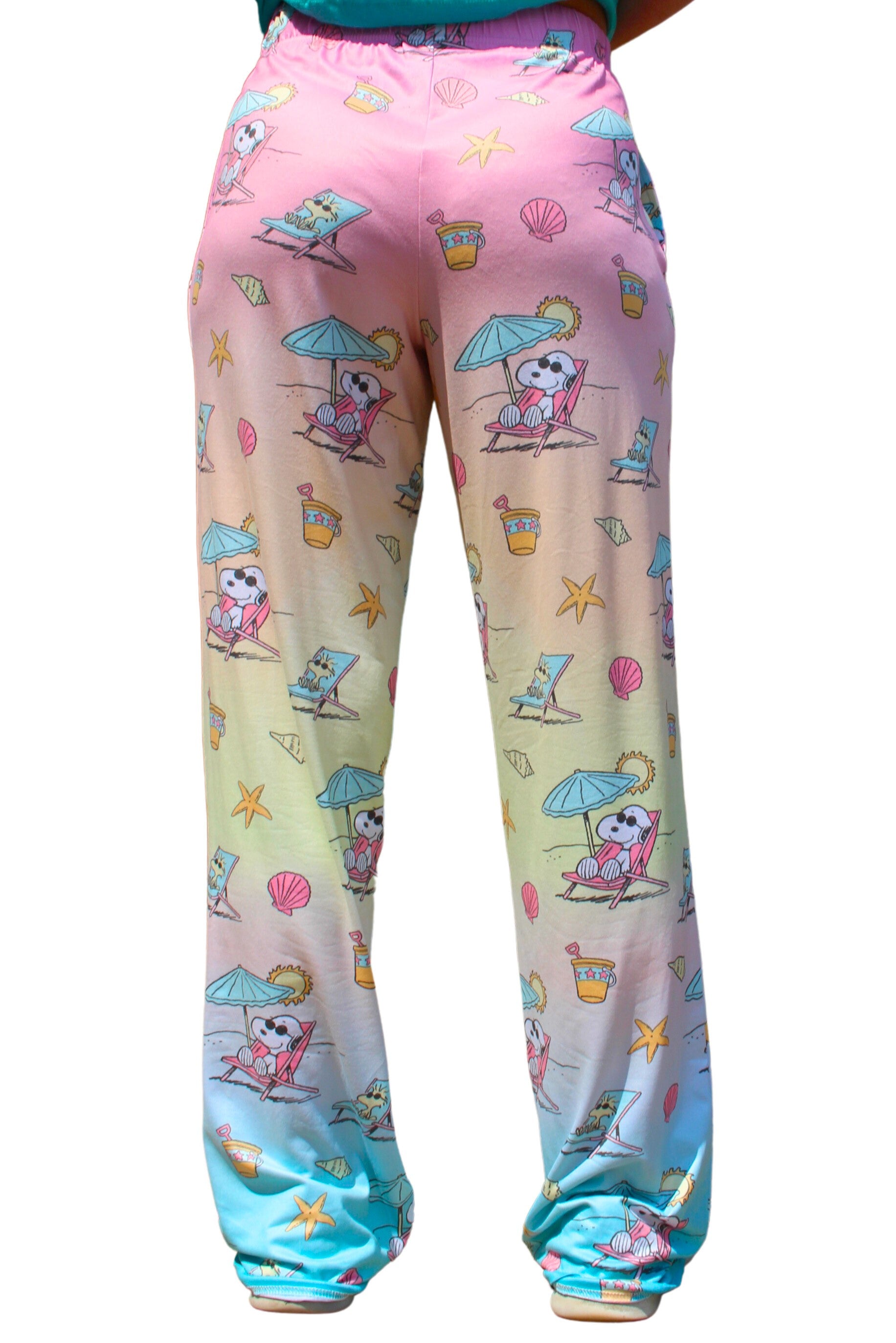 Person wearing Brief Insanity Lounge Pants—Peanuts Snoopy Beach, featuring fun cartoon beach vibes.
