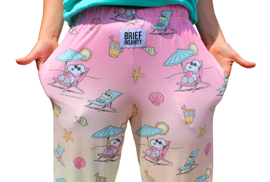 Product Image – Person wearing Brief Insanity Peanuts Snoopy Beach lounge pants, hands in pockets.