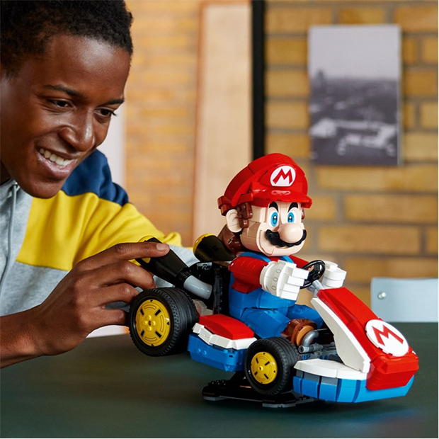 Someone plays with the LEGO® Mario Kart™ – Mario & Standard Kart set by LEGO in a casual indoor setting.
