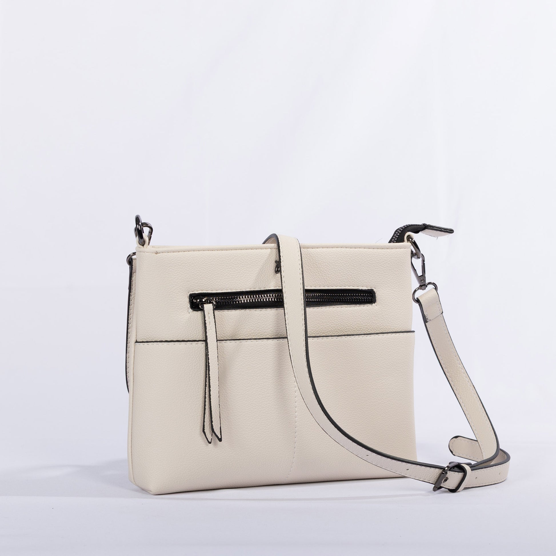 The Miss Caprice Front Zipper Crossbody is cream-colored with easy-access pockets and an adjustable strap.
