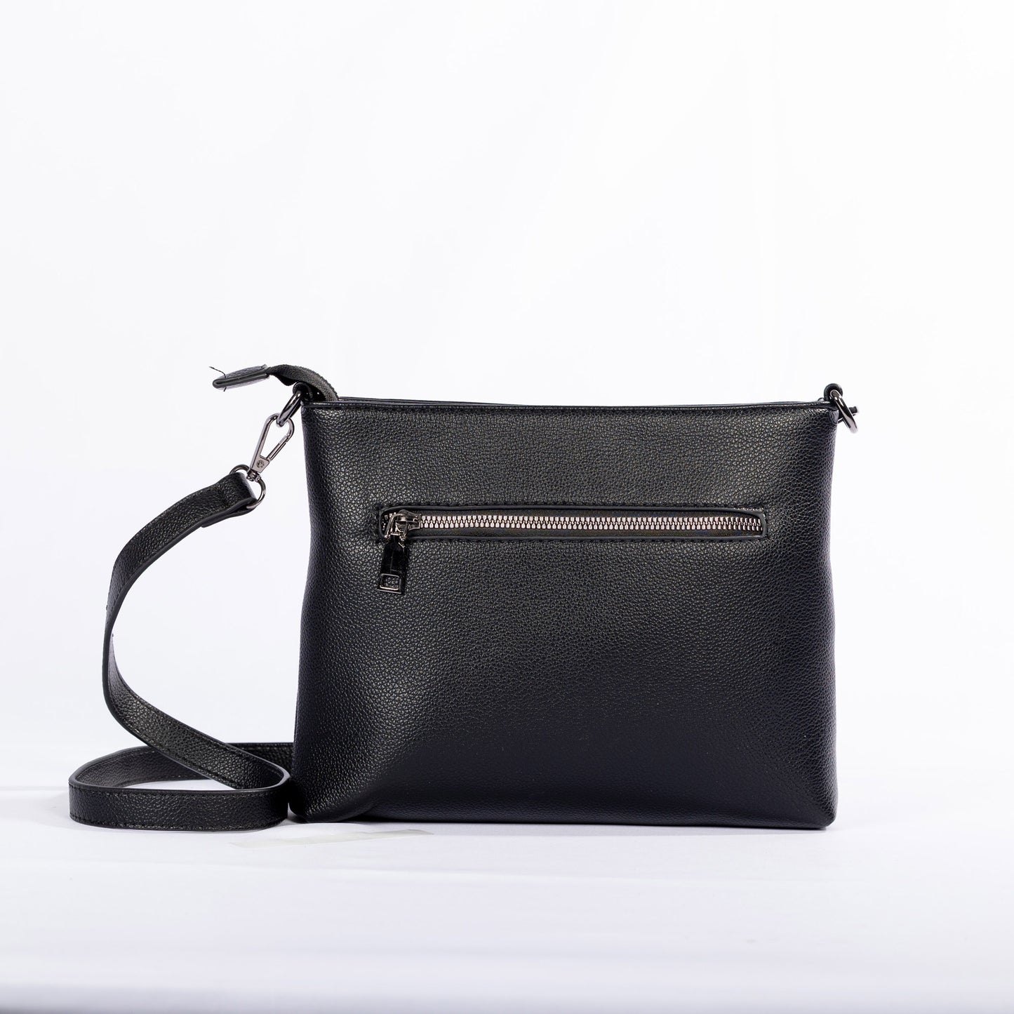 The Miss Caprice Front Zipper Crossbody is a black leather bag with easy-access pockets and adjustable strap, back view.