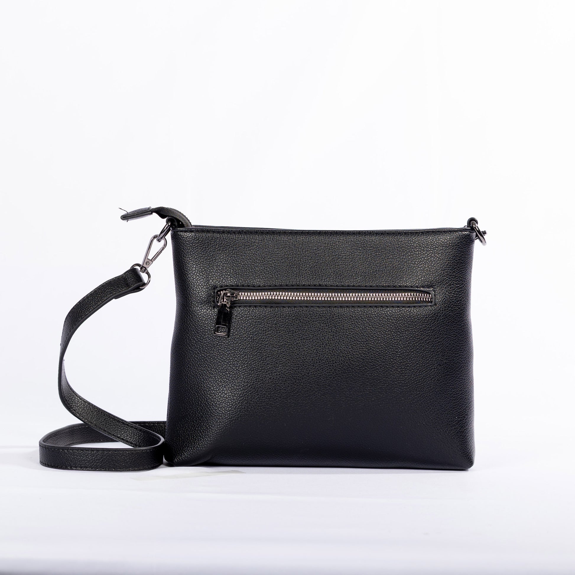 The Miss Caprice Front Zipper Crossbody is a black leather bag with easy-access pockets and adjustable strap, back view.