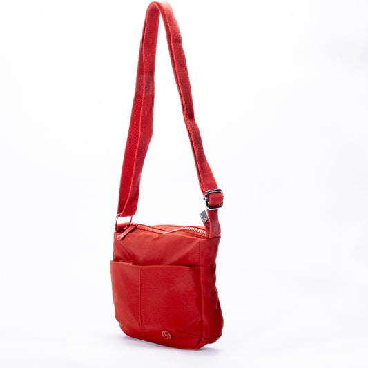 Product Image – The Miss Caprice Small Nylon Crossbody, red with front pocket and adjustable strap, is shown on a white background.