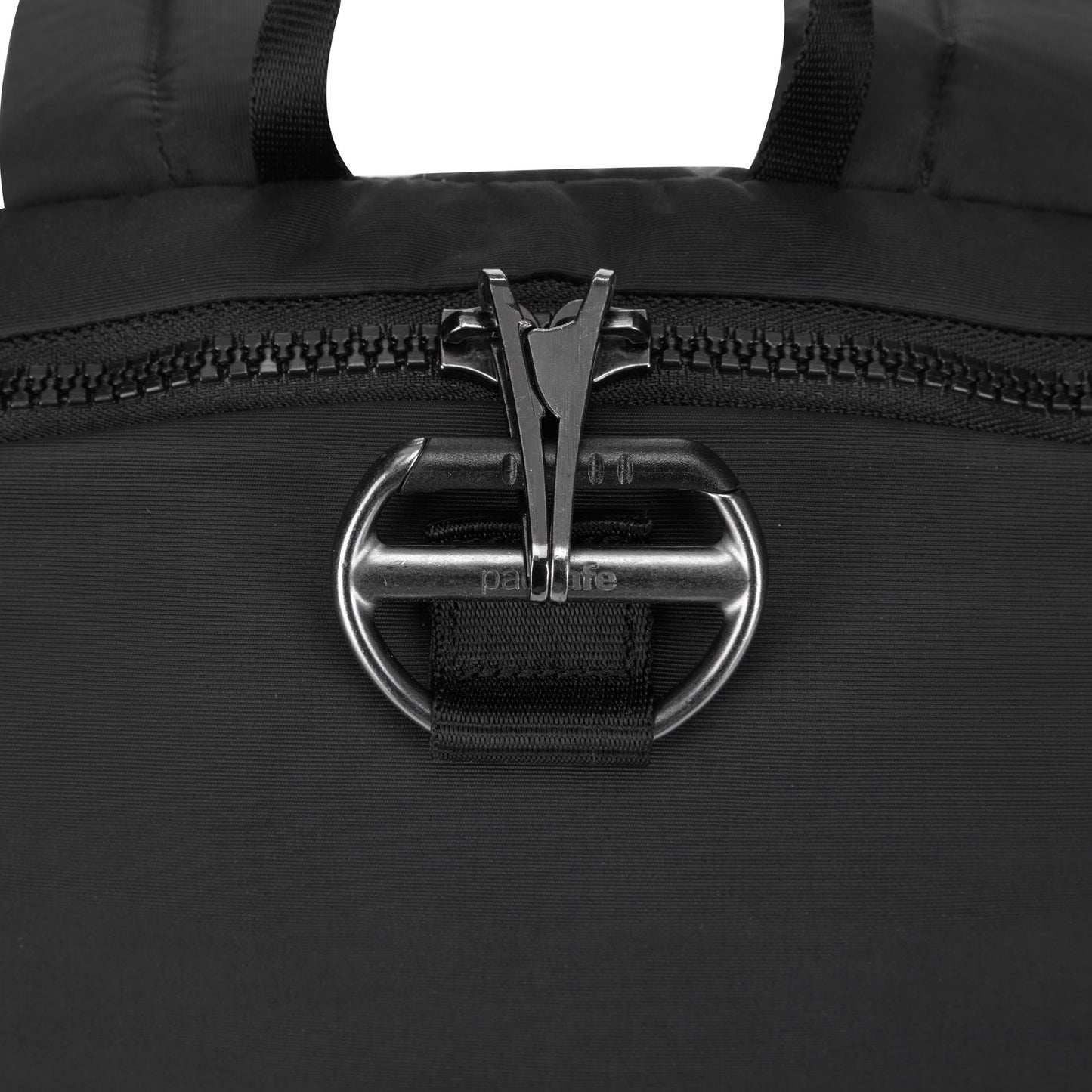 Close-up of a black Pacsafe CX 8L anti-theft backpack with dual zippers and a metallic clip latch mechanism.