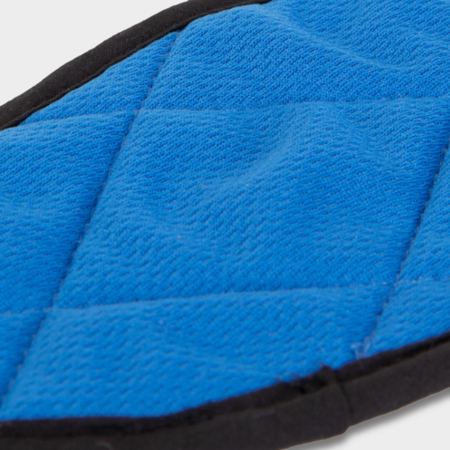Close-up of a blue quilted pad with black trim, featuring the Tilley HyperKewl™ Cooling Insert.