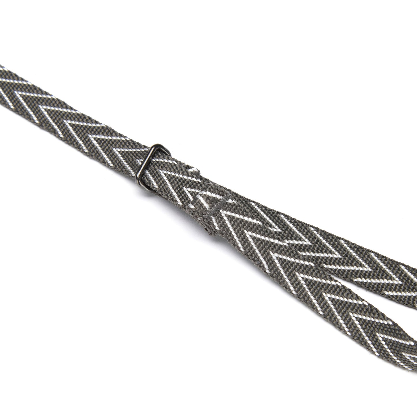 Gray and white chevron Pacsafe® camera strap with black adjustable slide; features cut-resistant design.