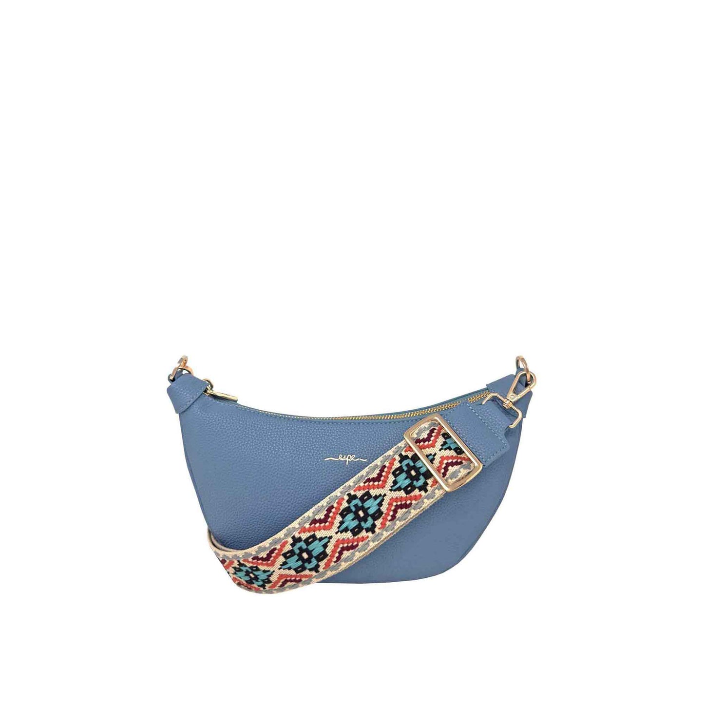 The Espe Crescent Crossbody is a blue leather bag with a trendy, colourful cotton strap.