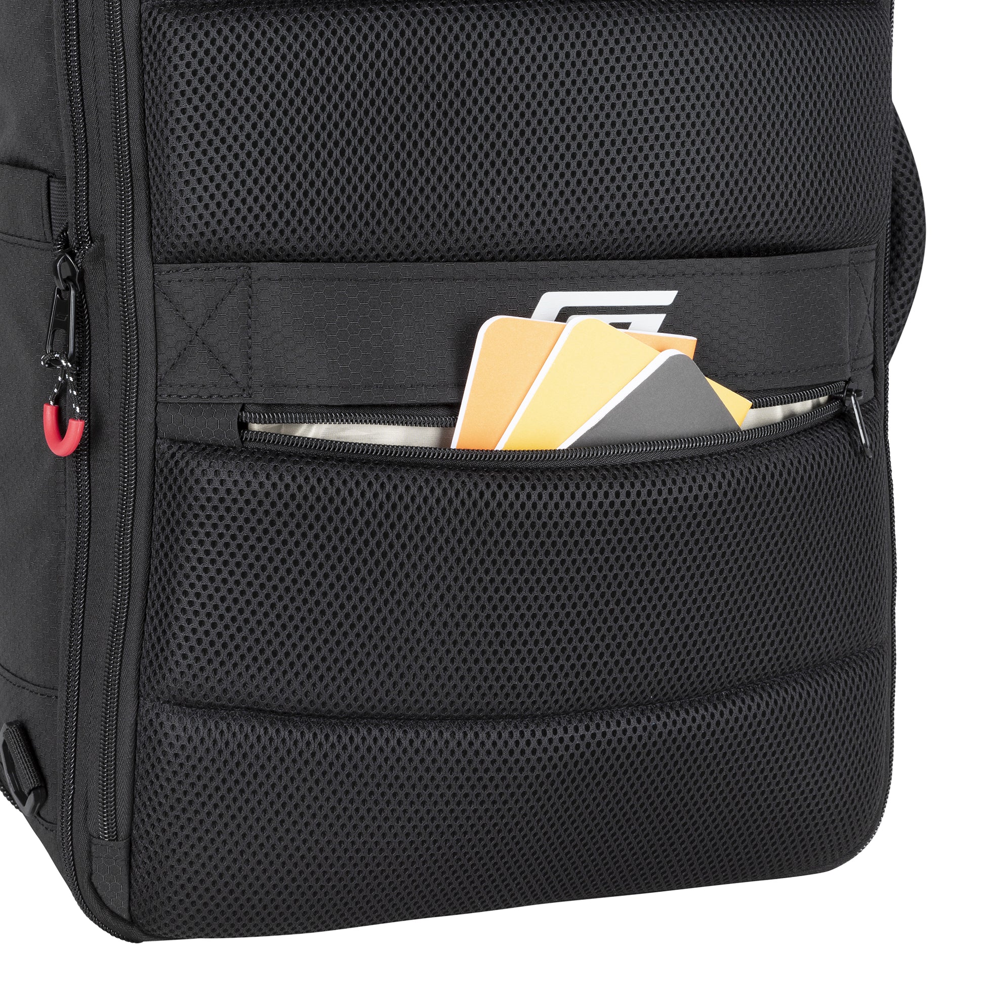 A close-up of the Graphite Metamorph Convertible Travel Backpack pocket with notebooks, a folder, and a document.