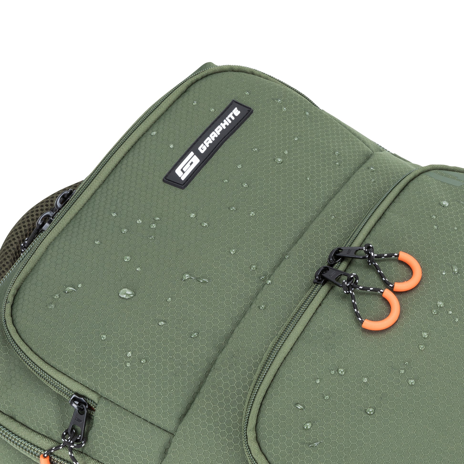 Close-up of Graphite Metamorph Convertible Travel Backpack with water droplets, black zippers, and orange pull tabs.