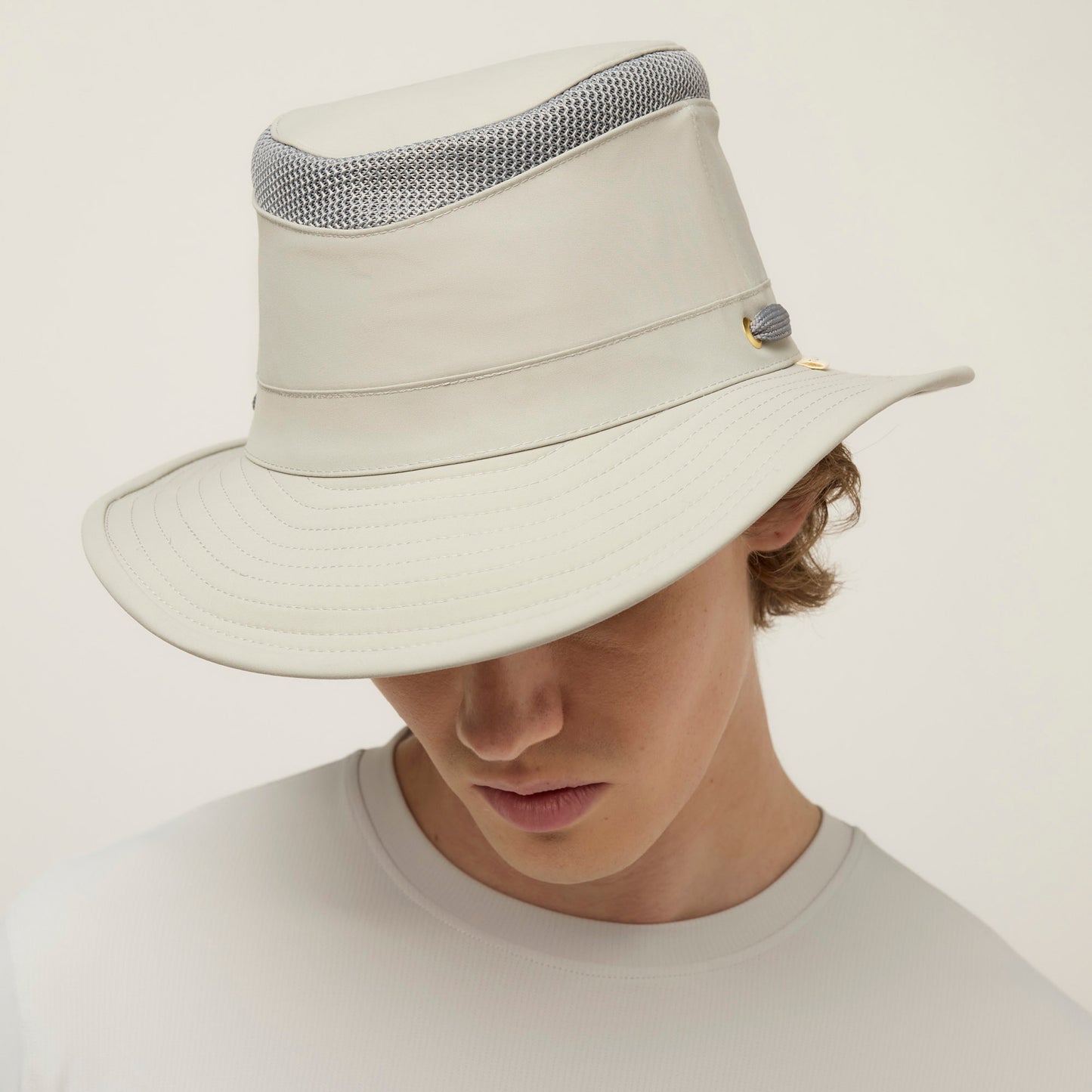 Person wearing a Tilley LTM5 Airflo® Hat with mesh ventilation, head slightly down, in a light shirt.