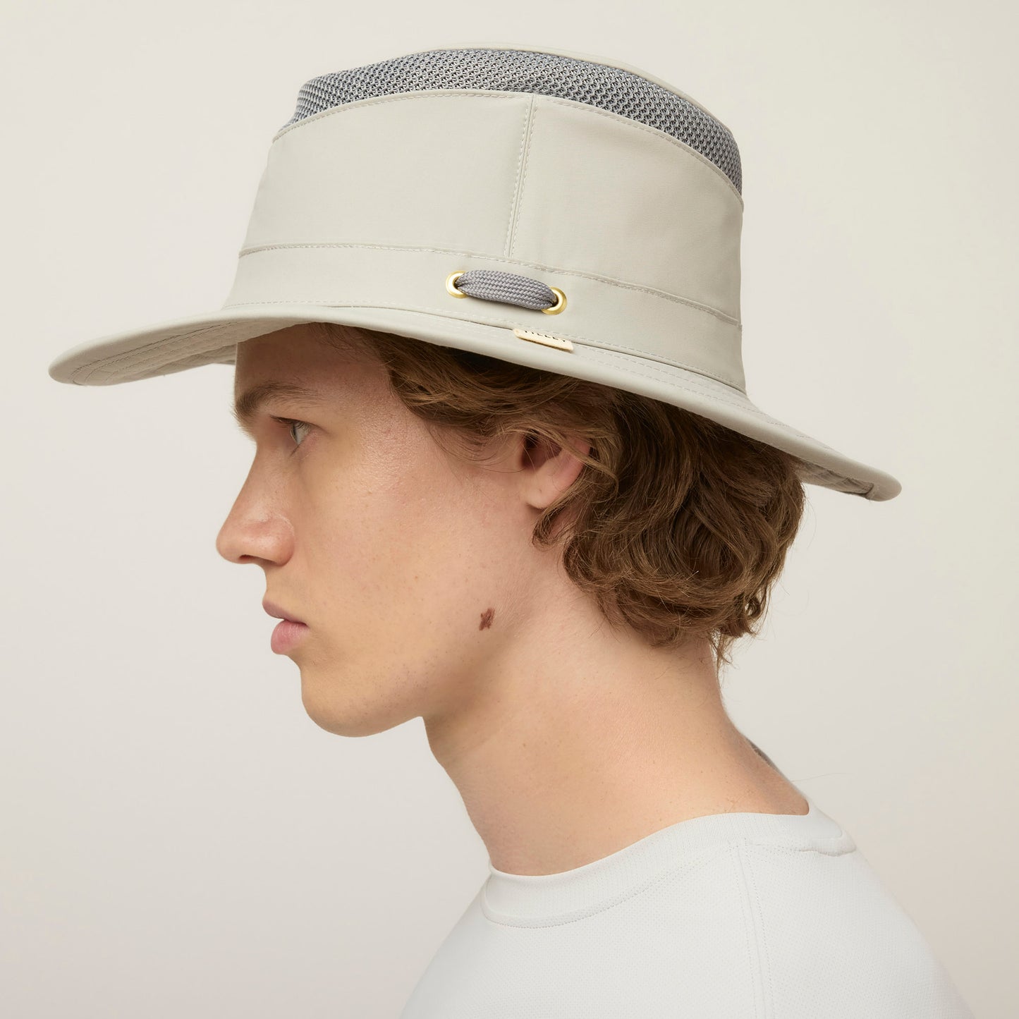 A person in a Tilley LTM5 Airflo® Hat and white shirt, shown in left profile against a plain background.