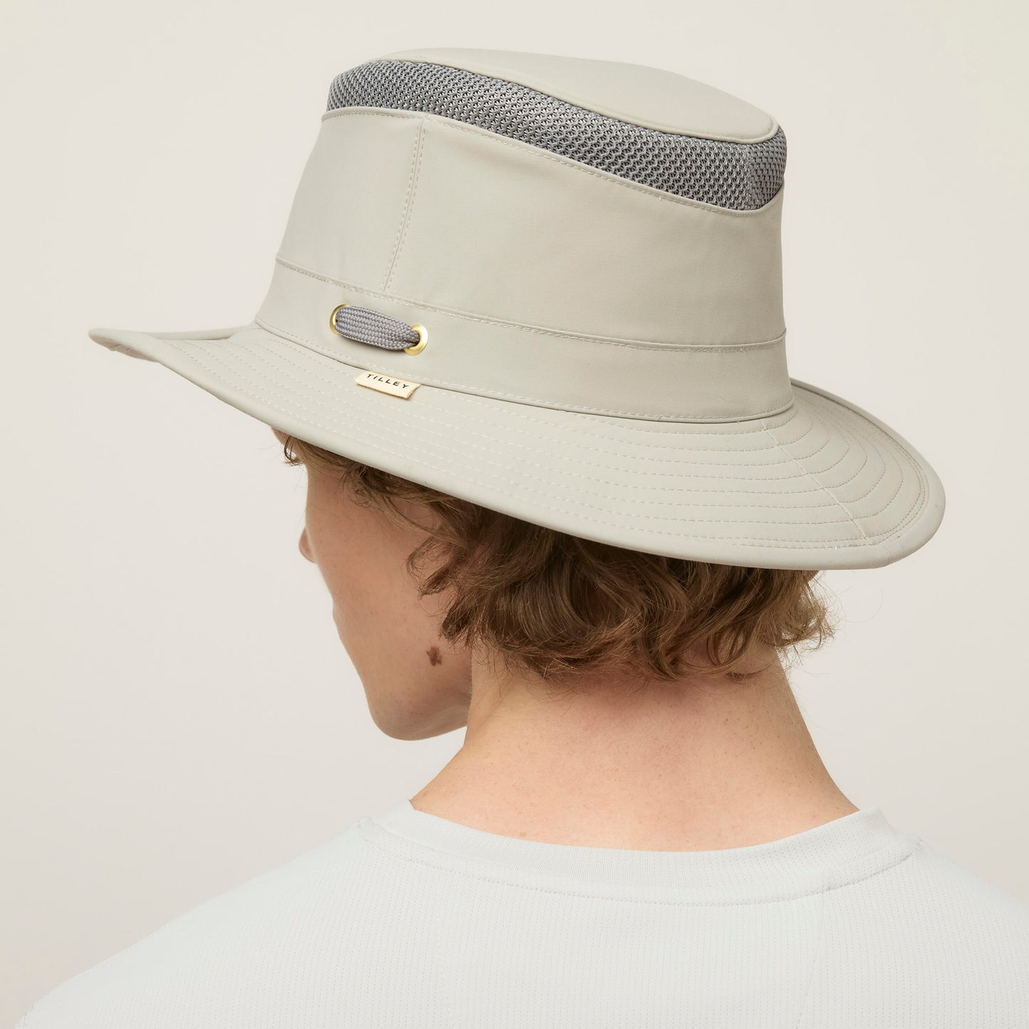 Person in a light gray Tilley LTM5 Airflo® Hat with mesh ventilation, seen from behind.