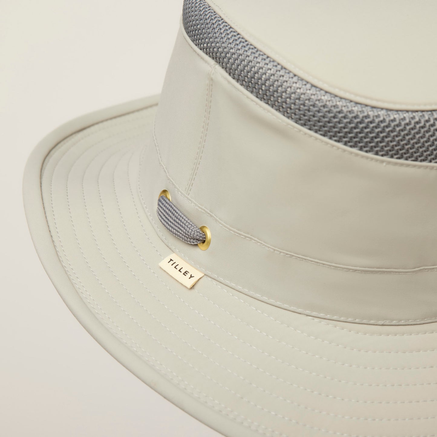 Close-up of a Tilley LTM5 Airflo® Hat featuring sun-blocking fabric and a gray mesh ventilation band.