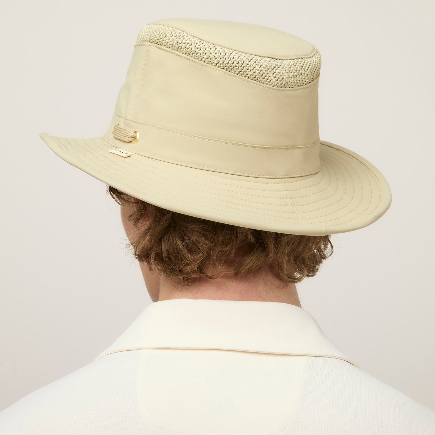 Person wearing a Tilley LTM5 Airflo® Hat with sun-blocking wide brim, viewed from behind.