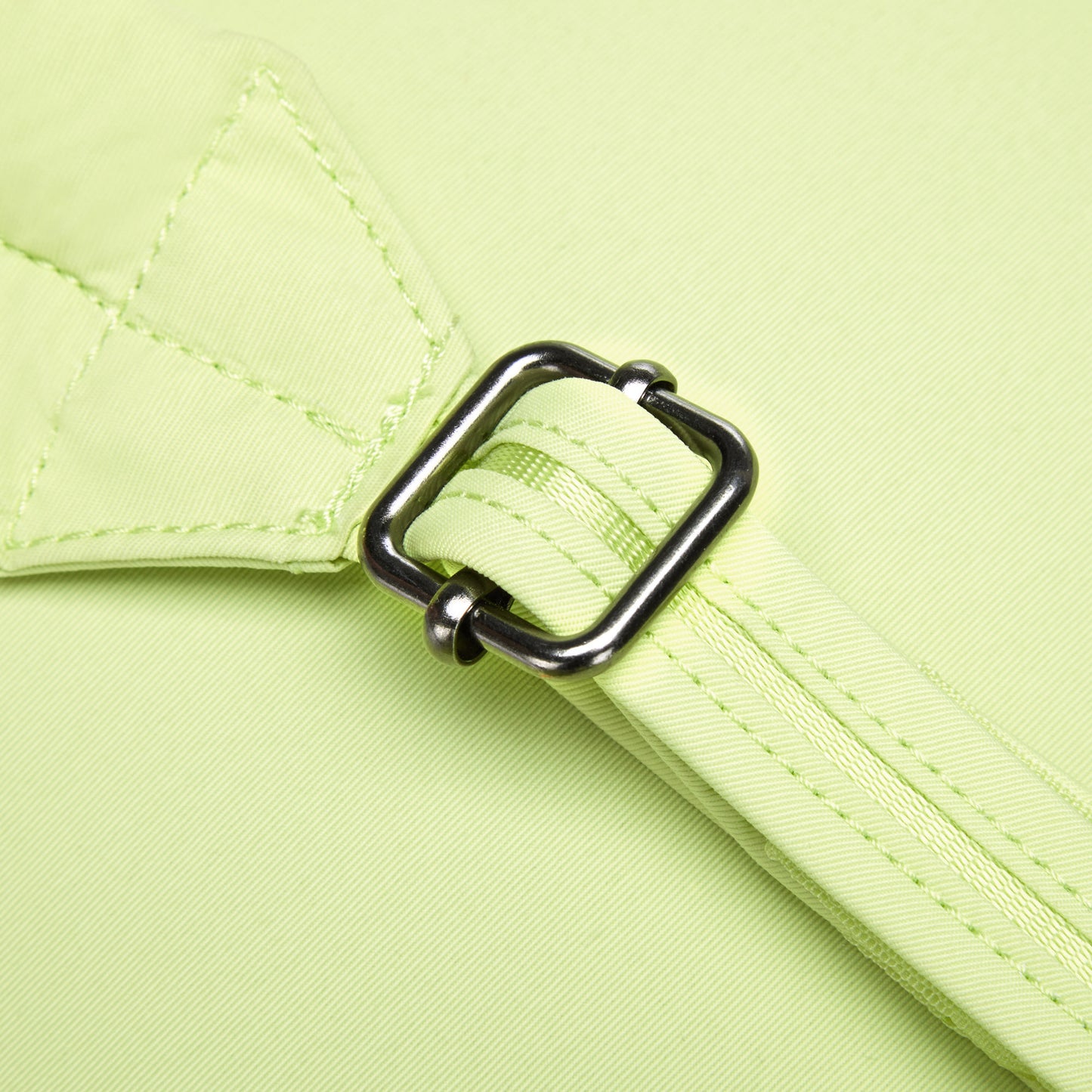 Close-up of a metal buckle on the Pacsafe® CX Anti-theft 8L Backpack Petite in matcha green fabric strap.