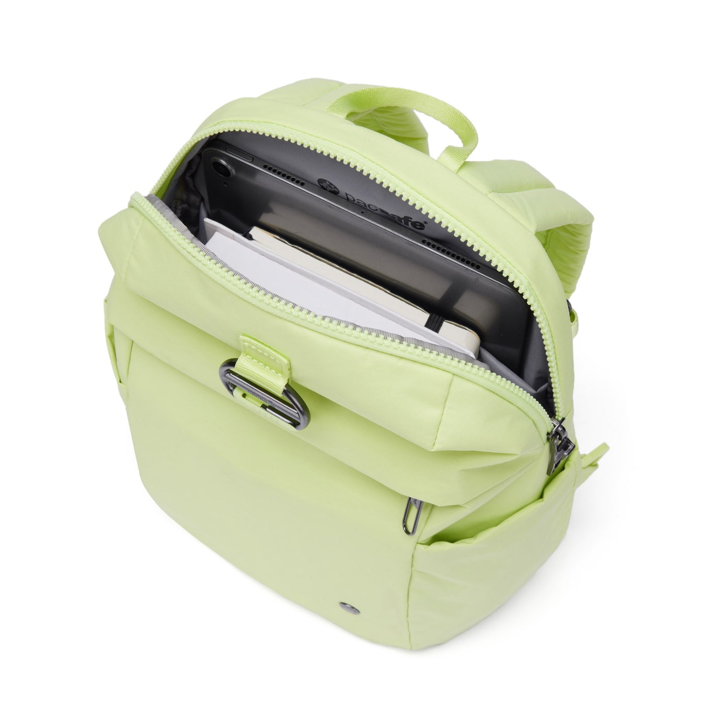 Open Pacsafe® CX Anti-theft backpack in matcha green with a tablet, notebook, and folders visible inside.