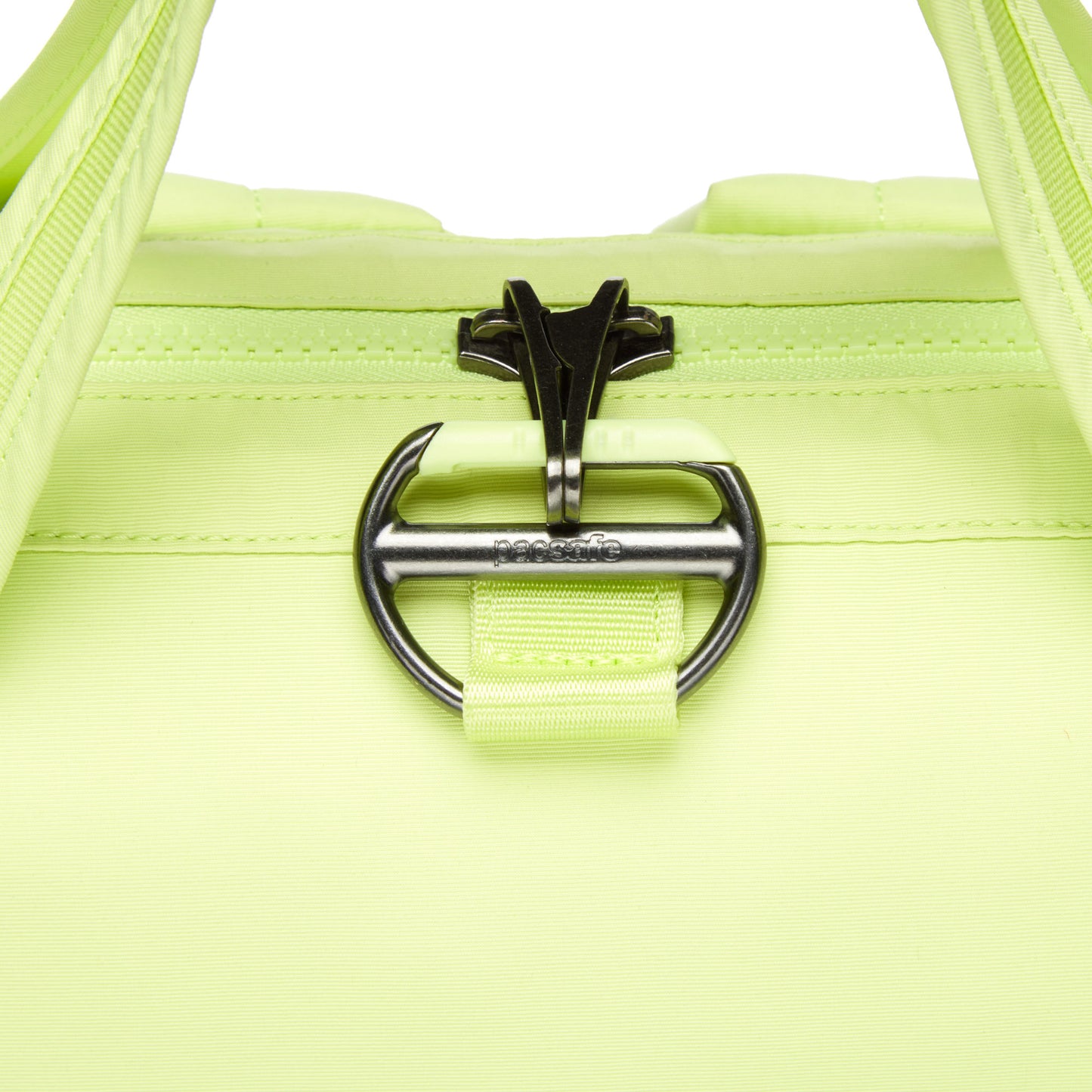 Close-up of the matcha green Pacsafe CX Anti-theft 17L Backpack with visible zipper and metal buckle in the center.