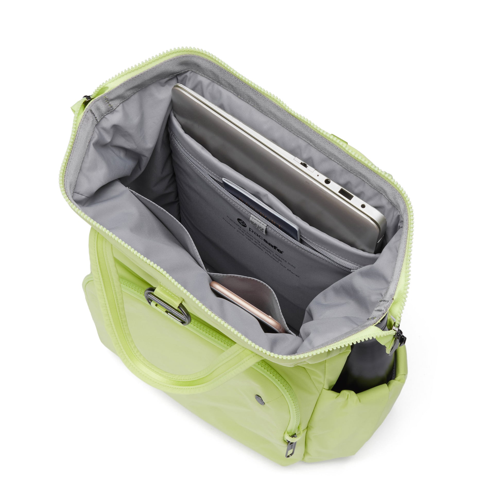 Open view of matcha green Pacsafe® CX 17L Backpack with recycled polyester, anti-theft design holds a laptop and smartphone.