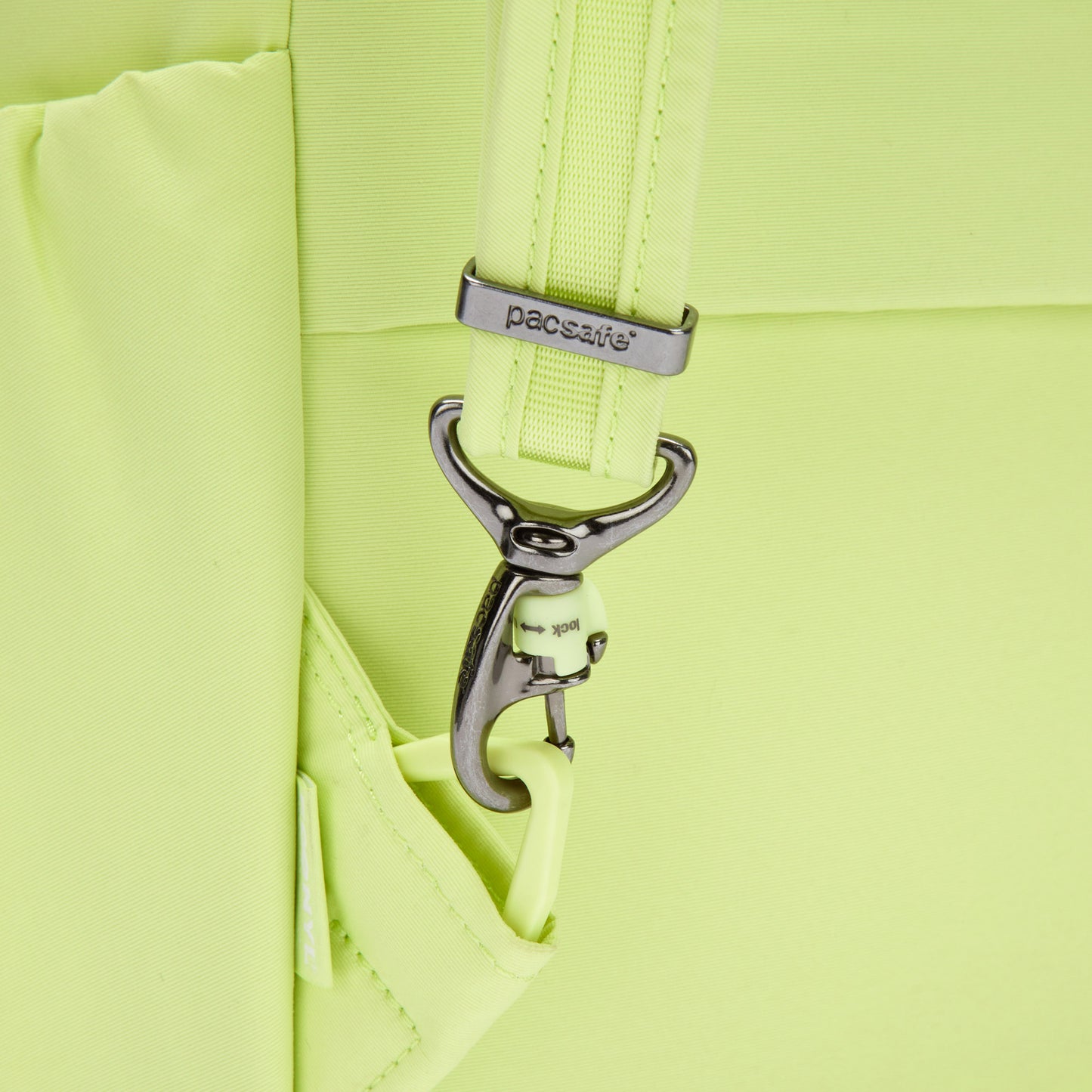 Close-up of a matcha green Pacsafe® CX Anti-theft 17L Backpack made with recycled polyester and a hooked strap.