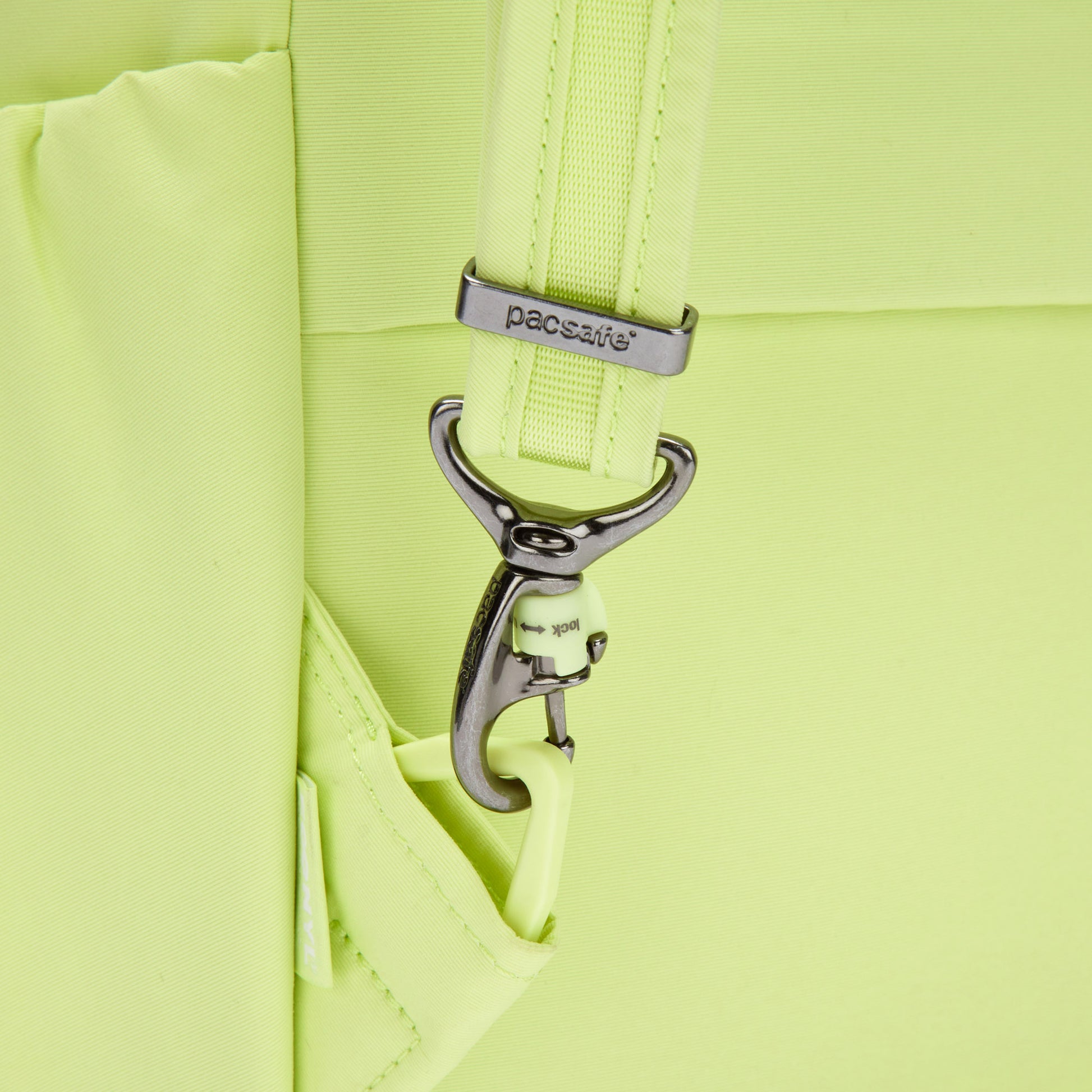 Close-up of a matcha green Pacsafe® CX Anti-theft 17L Backpack made with recycled polyester and a hooked strap.