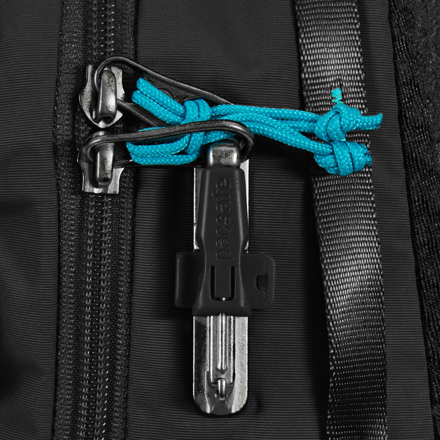 Close-up of Pacsafe® ECO 12L Anti-theft Sling Backpack with ambidextrous design, black zipper, blue cable, and lock.