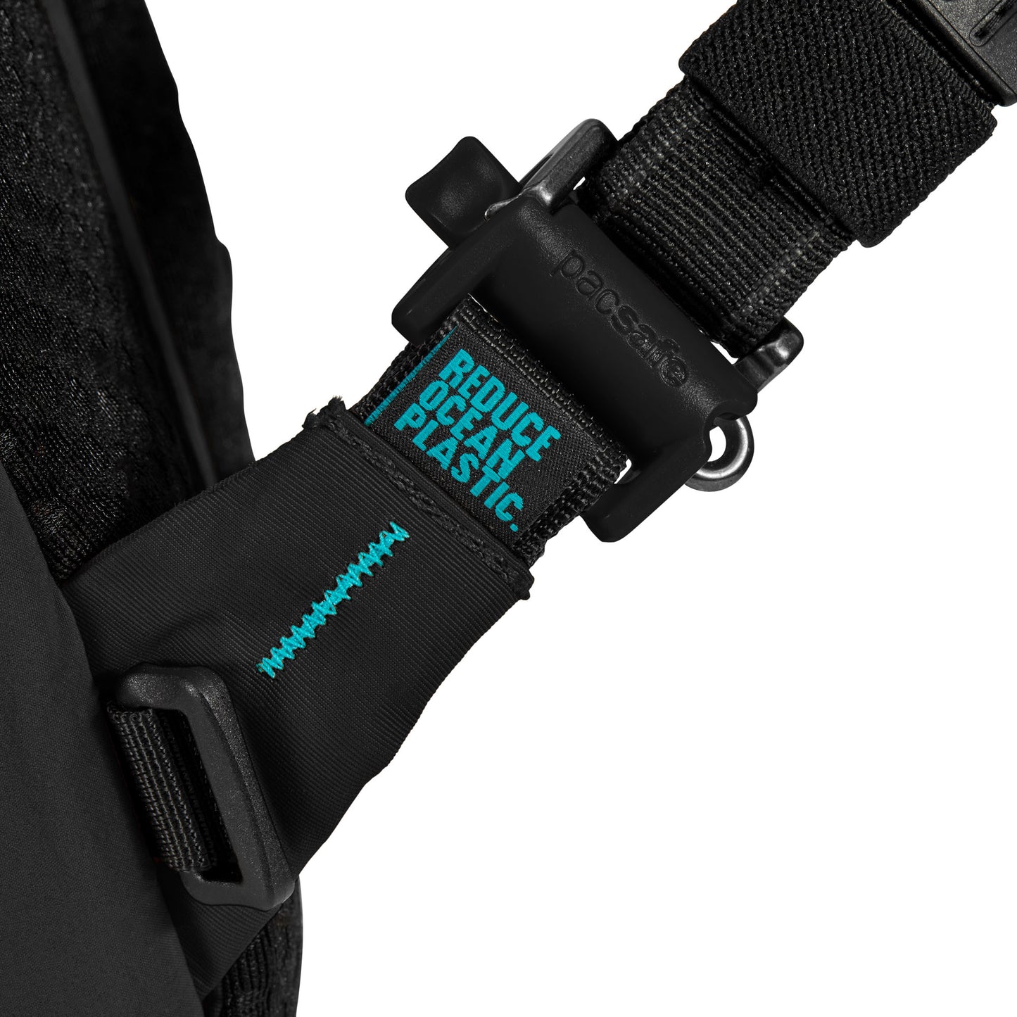 Close-up of a black strap from the Pacsafe® ECO 12L Backpack with a turquoise "Reduce Ocean Plastic" label.